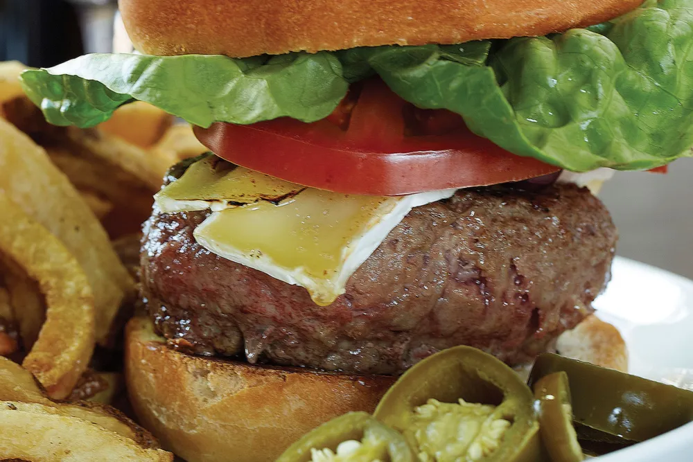 The Signature Blend Burger with Wine Dive frites and house made pickled jalapeños. Photo credit: MWD Marple for MAX'S Wine Dive Shows How to Get More Comfort Food in Your Life