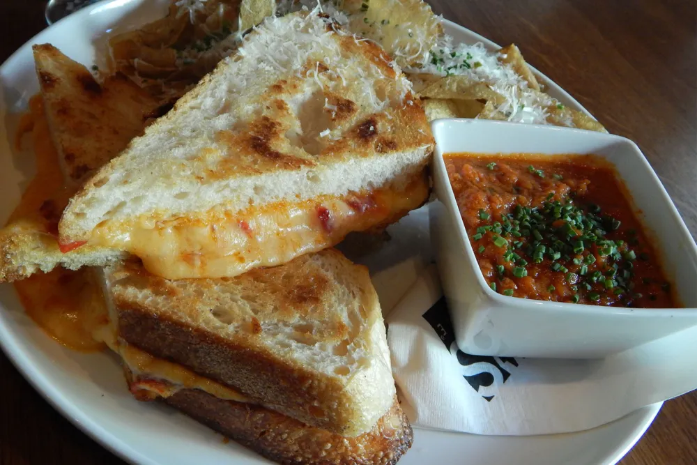 Toasted artisan bread with Gruyère, provolone and roasted red bell pepper "pimento and cheese". Photo credit: MWD for MAX'S Wine Dive Shows How to Get More Comfort Food in Your Life