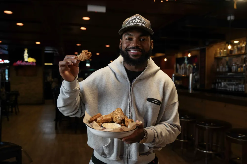 D'Andre Swift at Jake Melnick's Showing "Swift City Wings" Special Menu Item