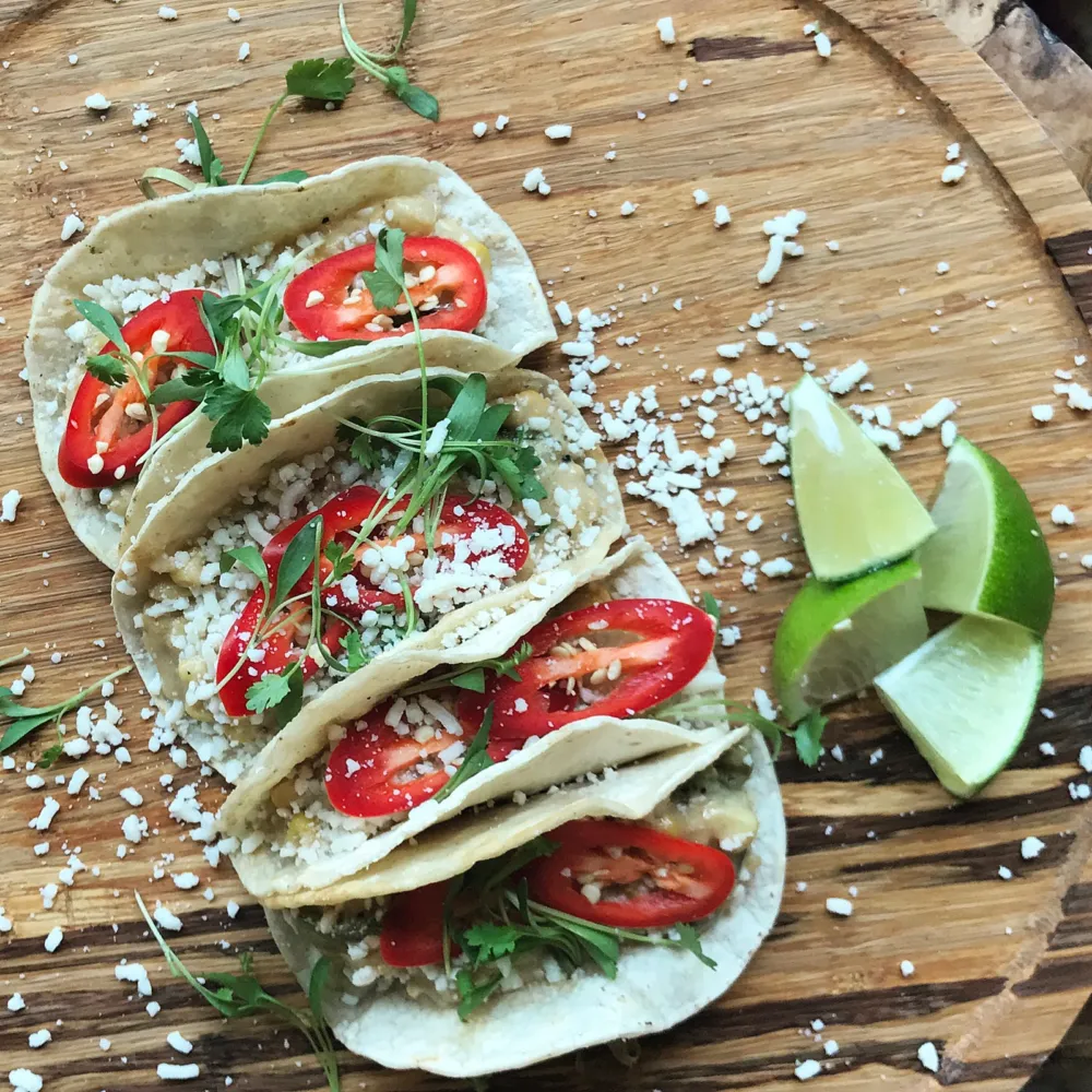 Roasted poblano taco platter topped with chihuahua cheese and fresno chili peppers for Taco Flights, Frozen Margs & More for Cinco de Mayo at Rhyme or Reason