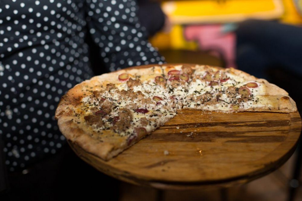 Wicker Park Pizza: fresh goat cheese, housemade Italian sausage and red grapes. 