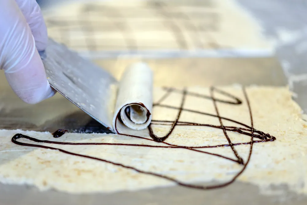 Scraping freshly frozen ice cream from the cold "wok" for Okashi Brings Thai Ice Cream with a Twist to Lakeview