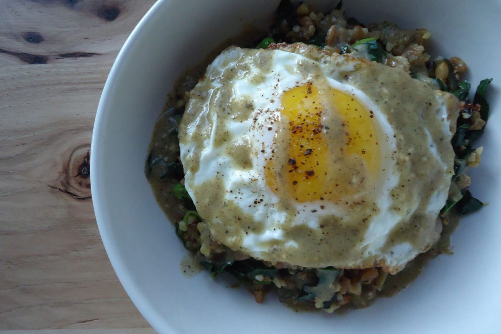 Warm grain salad shishito pepper, kale, tomatillo, sunny egg