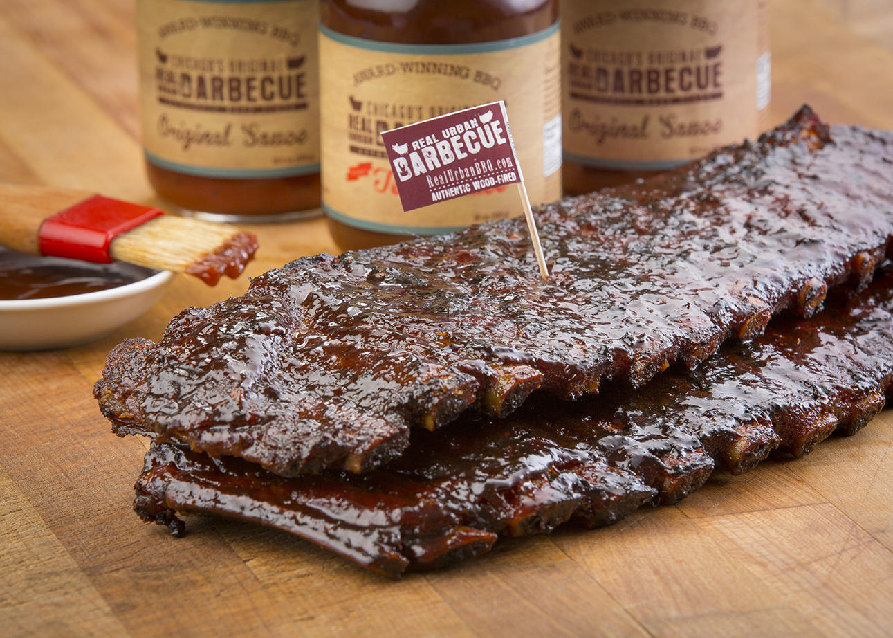 Racks Of Ribs Sauce In Background for Eat Your Feelings This Valentine's Day at Real Urban BBQ