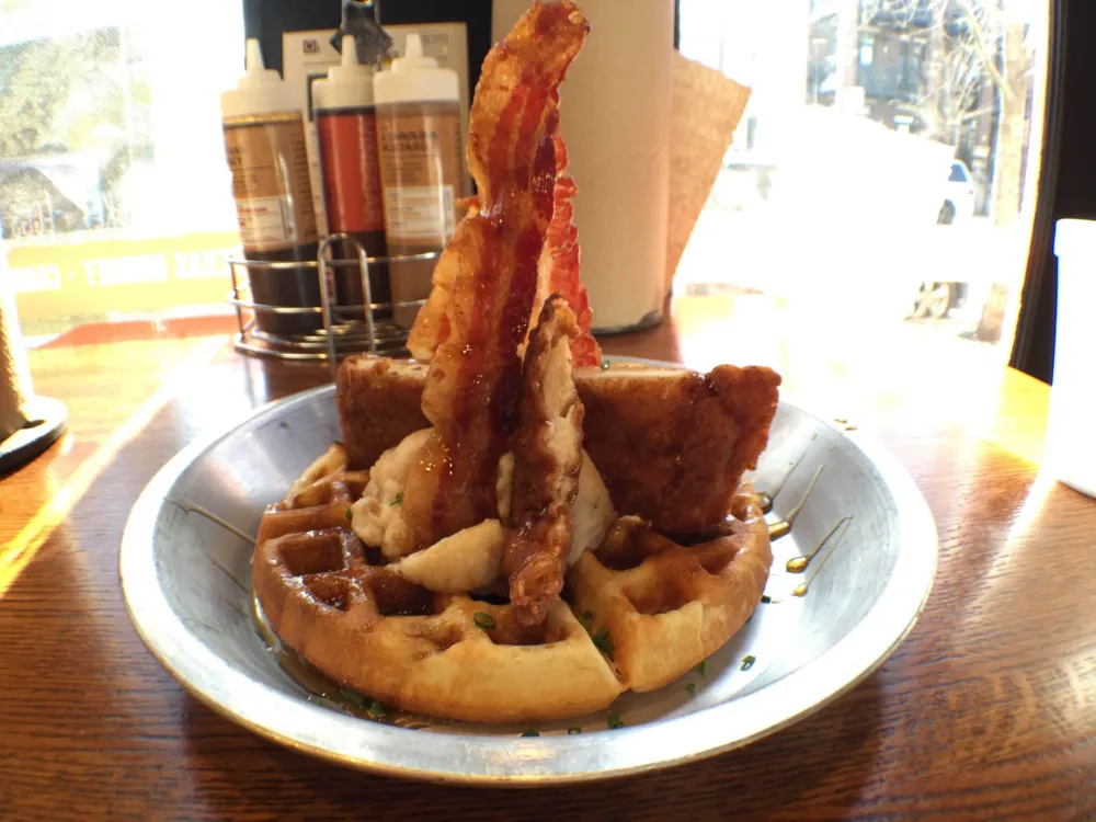 Buttermilk waffle topped with fried chicken, bacon, mashed potatoes and smoked syrup for Brunch and Barbeque: Q BBQ Shows You How to Do It