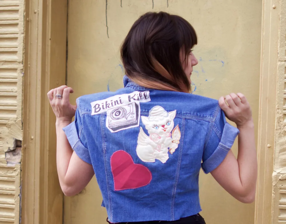 Anastasia Chatzka modeling one of her stylized denim jackets for Let's Get Patched Up at Rhyme Or Reason