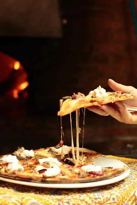 Pizz Macello Holding for Guns N' Roses Menu at Macello