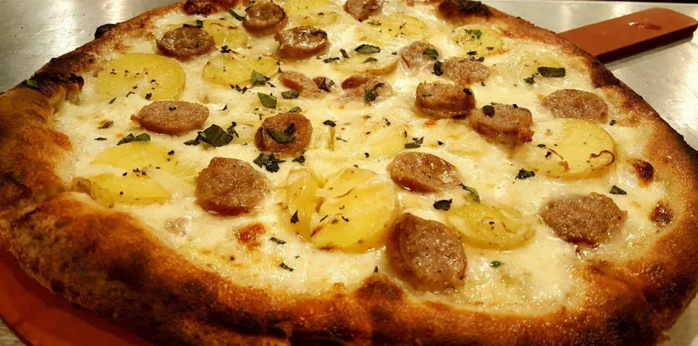 Bangers And Mash Pizza for St. Patrick’s Day & Pi Day this March at SLYCE Coal Fired Pizza
