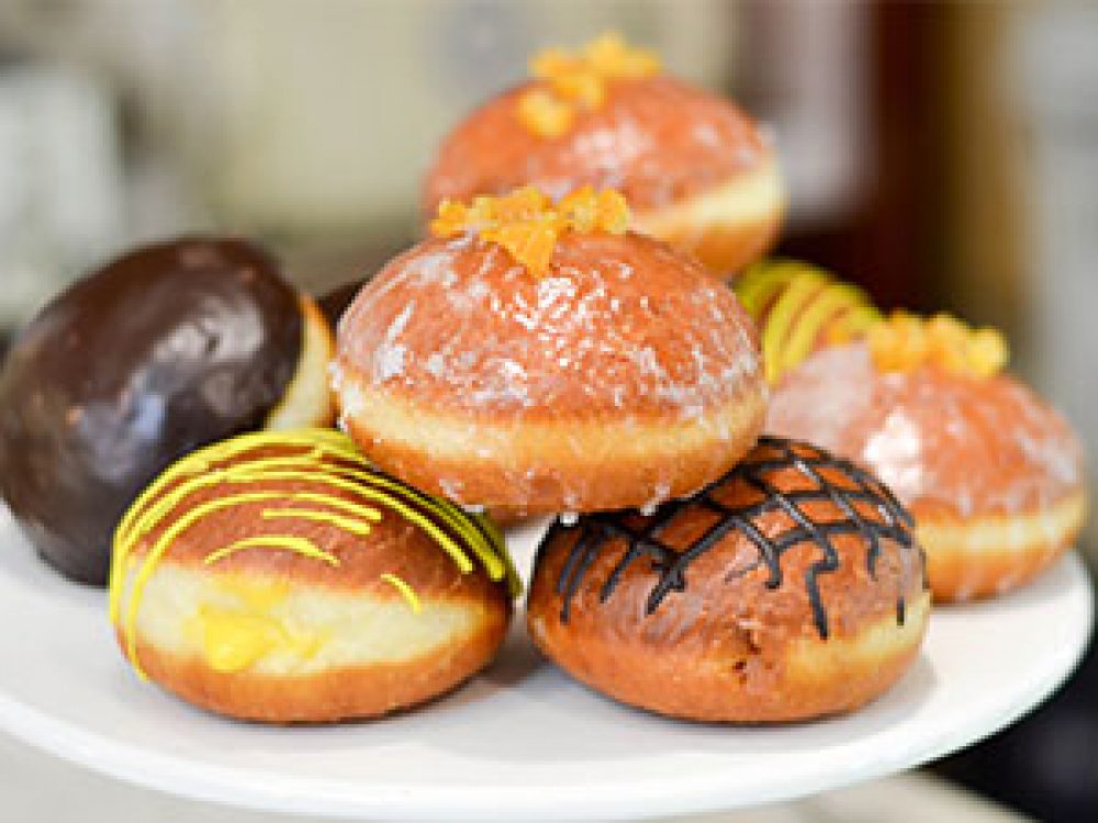 Assorted Paczki On Plate From Delightful Pastries
