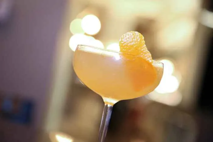 An American in Paris cocktail, made with Bache American Oak aged French Cognac, Grand Marnier, Calamansi French sipping vinegar and orange saffron bitters. for "An American in Paris" Brunch at The Blanchard