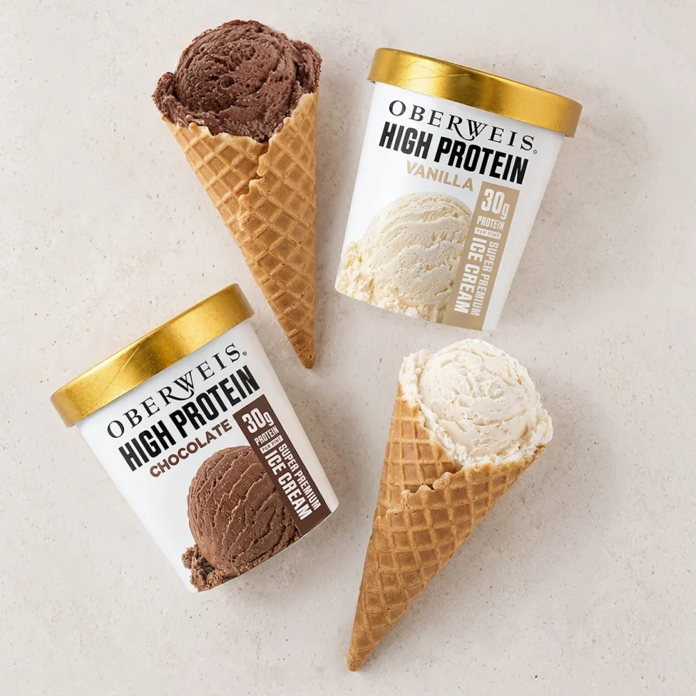 Protein ice cream chocolate vanilla waffle cone pint packaging on surface flat 1200x1200px for Where to Get the Scoop for National Ice Cream Month 2026