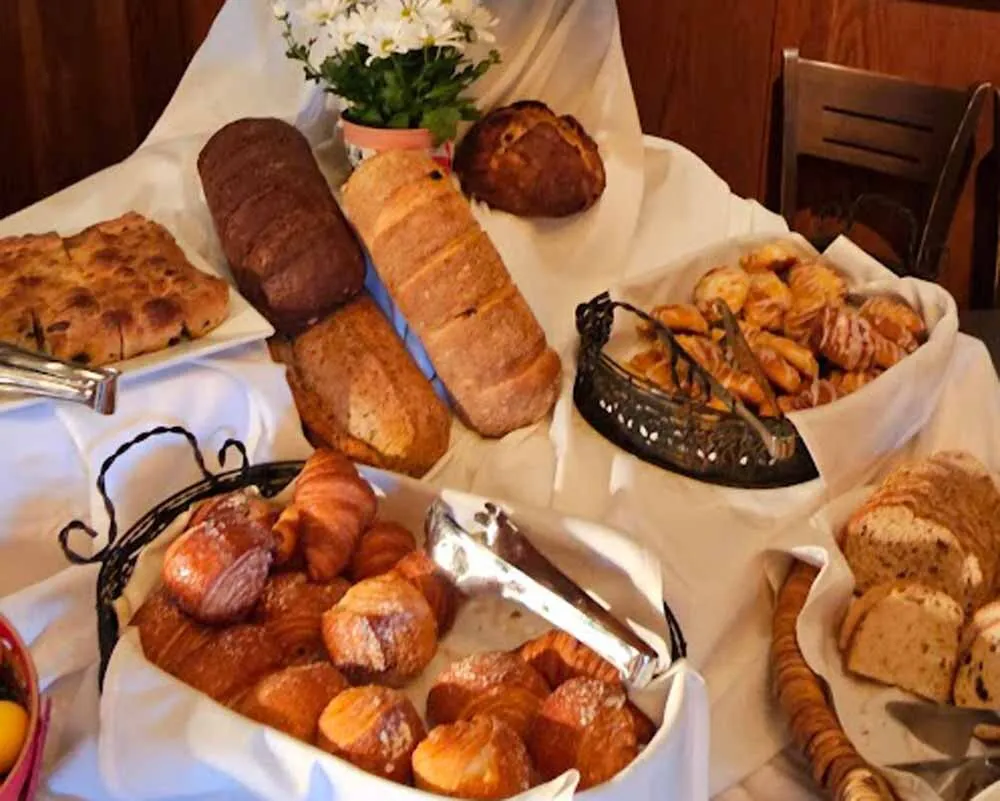 Crusty Multi Grain Artisan Breads, Mini Chocolate Croissants, Cheese Danish, Raspberry Jam Danish, Sticky Pecan Rolls