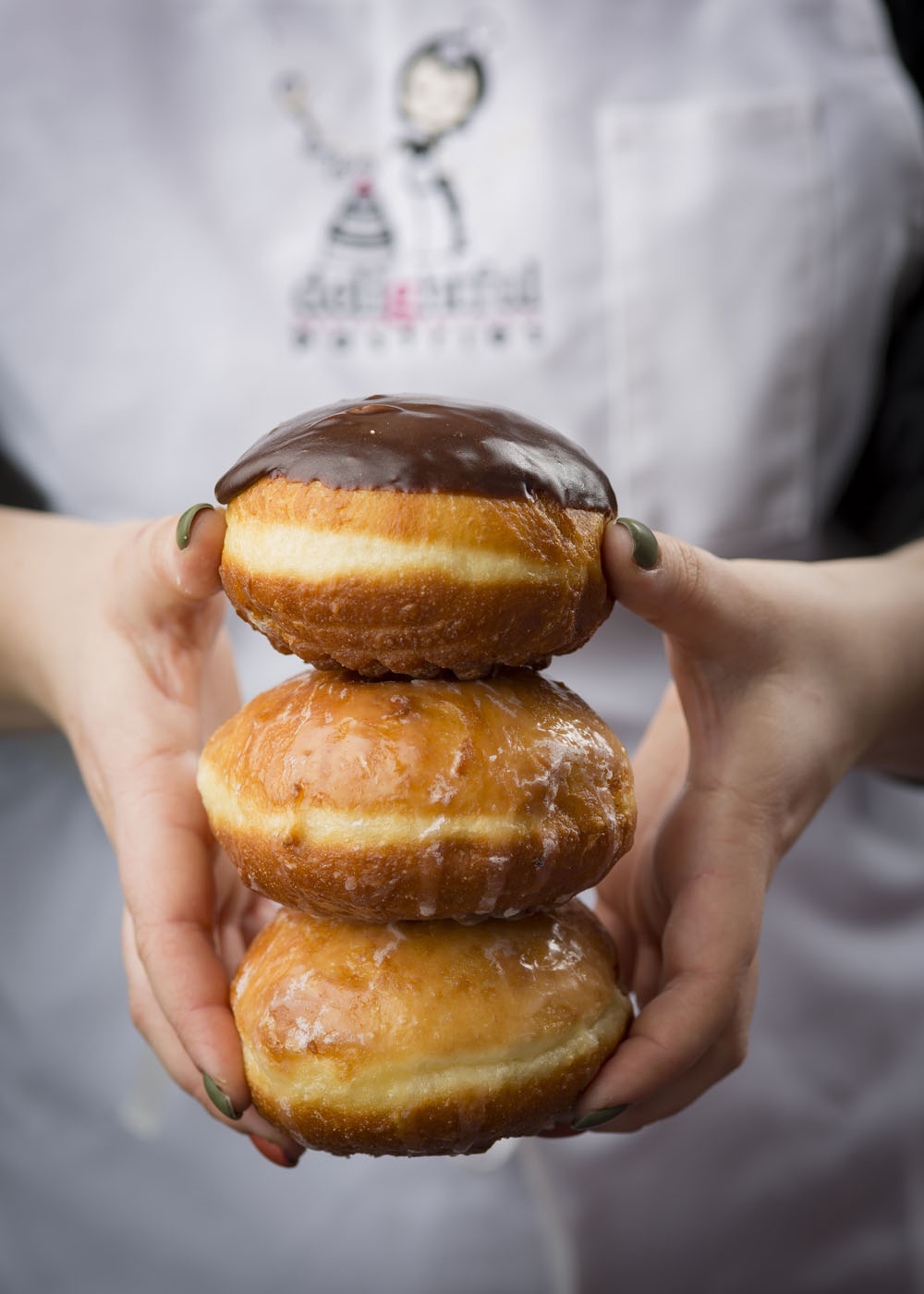 Packzi Stacked In Hands for Celebrate Fat Tuesday Feb. 16 with Paczki from Delicious Pastries