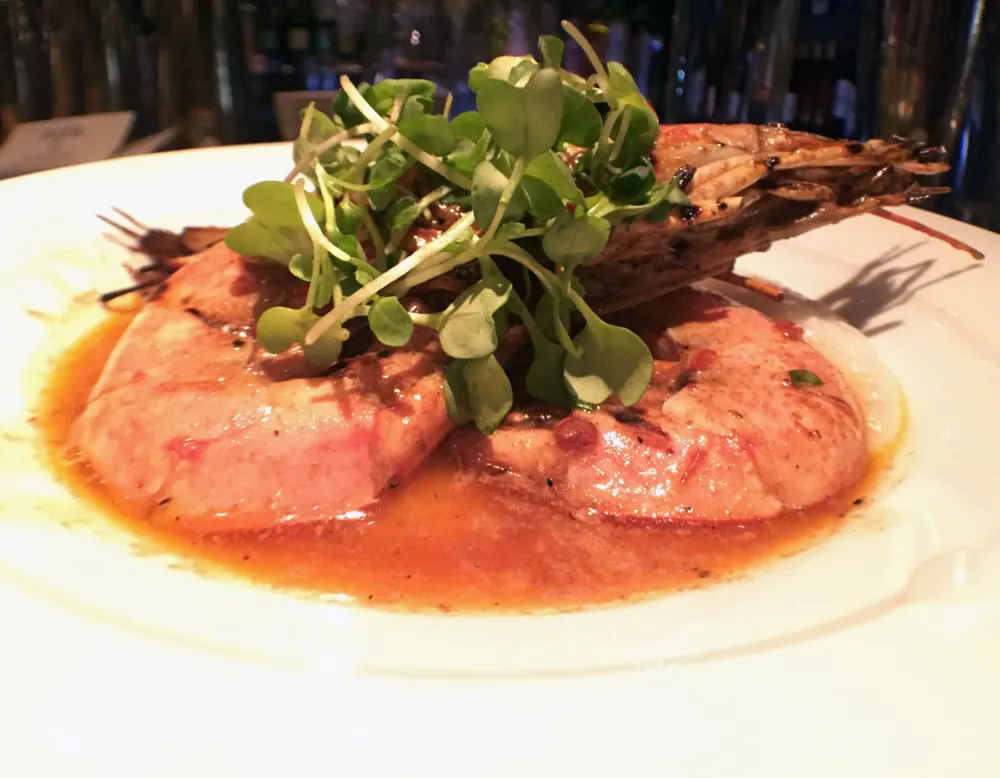 Grilled head on argentinian red shrimp with creamy grits, chipotle butter and micro wasabi for Ada Street's Restaurant Week Menu Finds Inspiration in Famous Last Meals