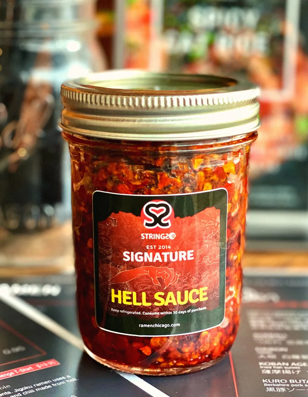 8 ounce jars Strings' Hell Sauce, available pick up or delivery, $15.95 for Strings Ramen Now Offers Jars of Hell Sauce to Go