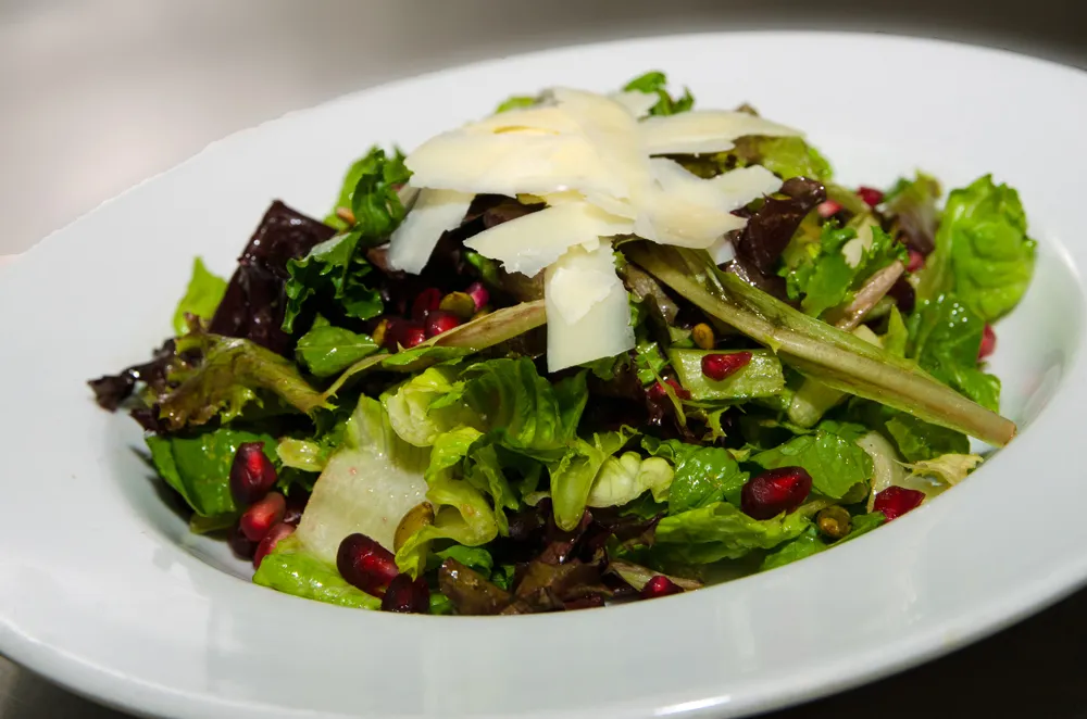 Mixed Green Salad with Apples, Pomegranate Seeds, Pumpkin Seeds, and Balsamic Vinaigrette. Photo credit: Cindy Kurman