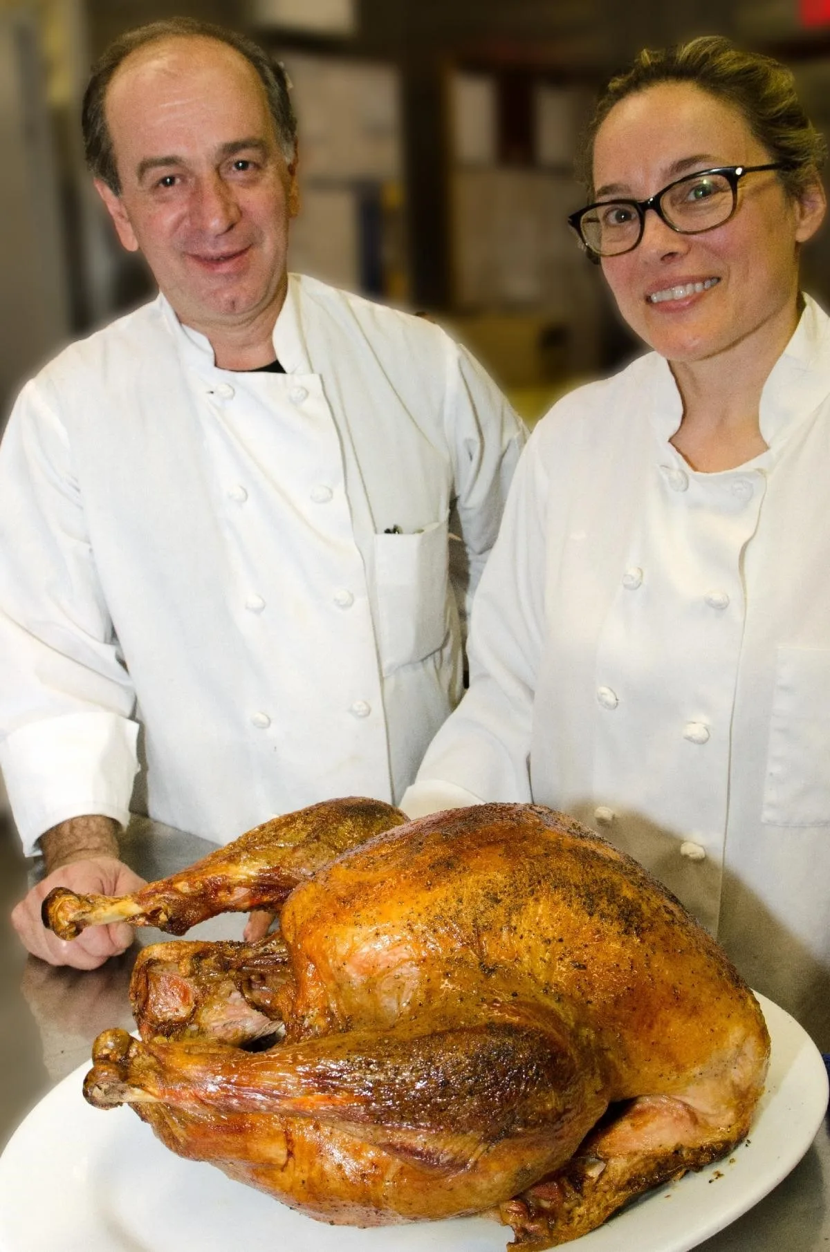 Chefs George Bumbaris And Sarah Stegner With Turkey for Prairie Grass Cafe Pre Thanksgiving Wine Pairing Event Nov. 2 and Thanksgiving To Go