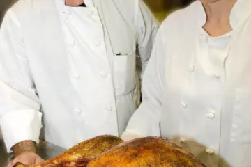 Chefs George Bumbaris And Sarah Stegner With Turkey for Prairie Grass Cafe Pre Thanksgiving Wine Pairing Event Nov. 2 and Thanksgiving To Go