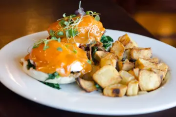 Eggs Benedict LR with potato photo by Cindy Kurman edited 2 for Prairie Grass Cafe to Host Easter Brunch and Offer Takeout Menu