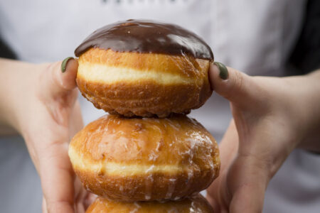 Packzi Stacked In Hands for Celebrate Fat Tuesday Feb. 16 with Paczki from Delicious Pastries
