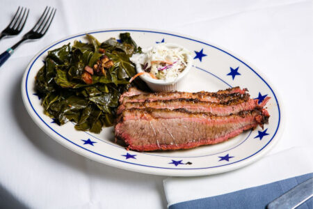 the local 0000 Cherry smoked sliced beef brisket with bacon collard greens and cole slaw for The Local Launches New BBQ Menu