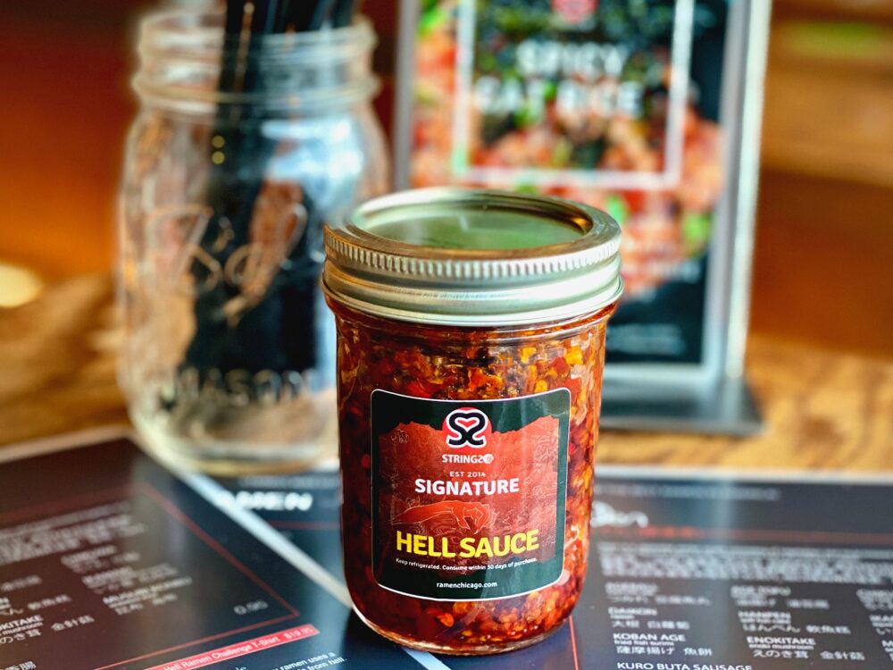 Strings' Hell Sauce combines Tian Jing, Szechuan and Thai chilis, along with other secret ingredients for Strings Ramen Now Offers Jars of Hell Sauce to Go