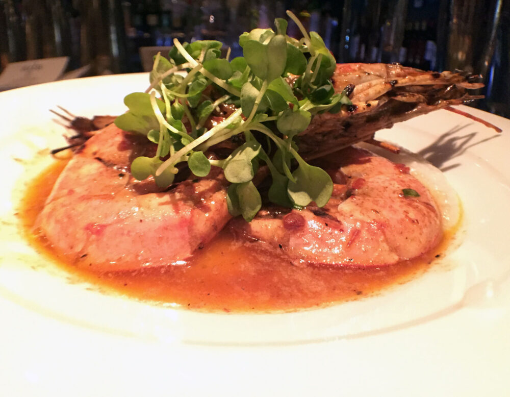 Grilled head on argentinian red shrimp with creamy grits, chipotle butter and micro wasabi for Ada Street's Restaurant Week Menu Finds Inspiration in Famous Last Meals