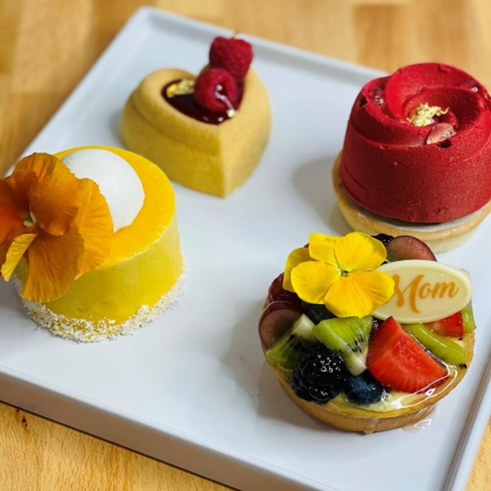 Treat mom to a box of fresh baked items which includes a selection of 4 petit gateaus with flavors like: rich milk and white chocolate mousse, vanilla cream, tropical and seasonal fruits. (Photo courtesy of Vanille Patisserie) for Celebrate Mom with these Mother's Day Offerings from Chicagoland Restaurants