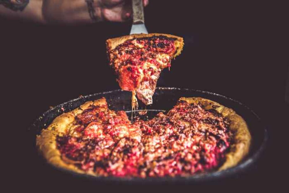 Finger Licking Foodie Tours' stops represent a who’s who of the deep dish world including Gino’s East on Superior Street with its fabled graffiti clad walls and celebrity clientele. (Photo courtesy of Gino's East) for Father's Day Dining, Gifts & Specials in Chicagoland