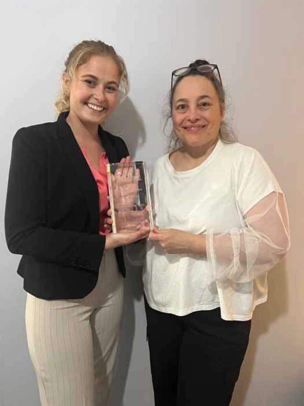 Hannah Rose Higdon and Sarah Stegner accepting award from Disability Matters for Prairie Grass Cafe Honored for its Sensory Friendly Hour Program