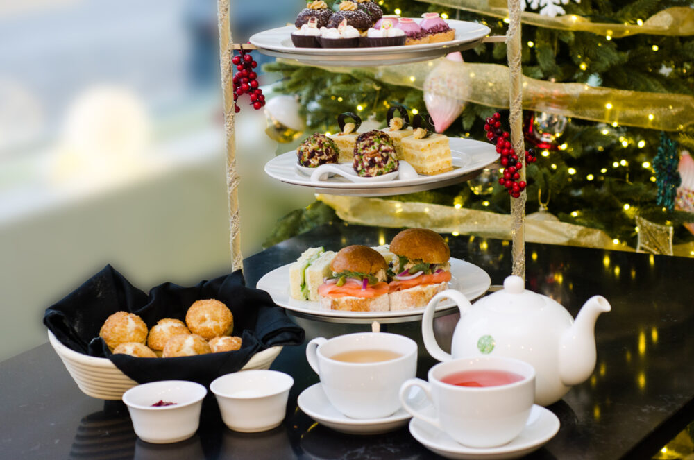 Holiday tea service begins with an assortment of sweet scones (bottom left) served with house made clotted cream and house made preserves.