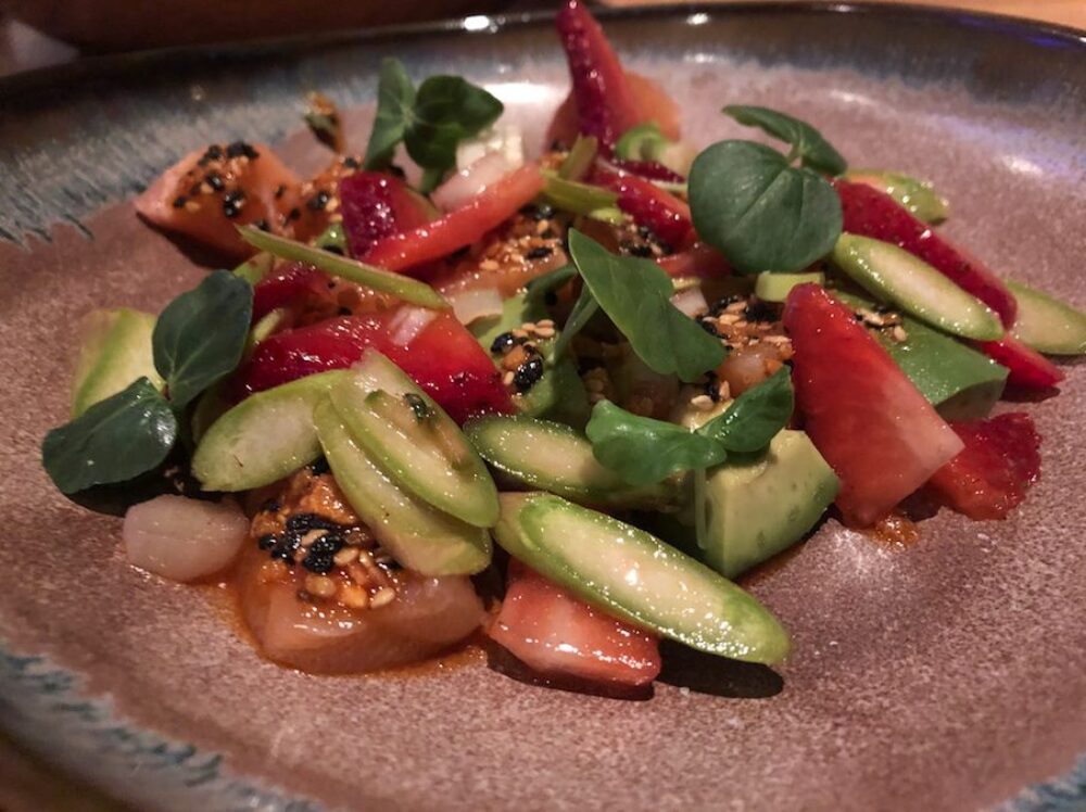 One of the first course dishes: Skuna Bay Salmon with chili crunch, strawberry, avocado and asparagus for ICYMI: Leading Chefs Came Together ‘Around the Table’ to Support the Alzheimer’s Association at Girl & the Goat May 4