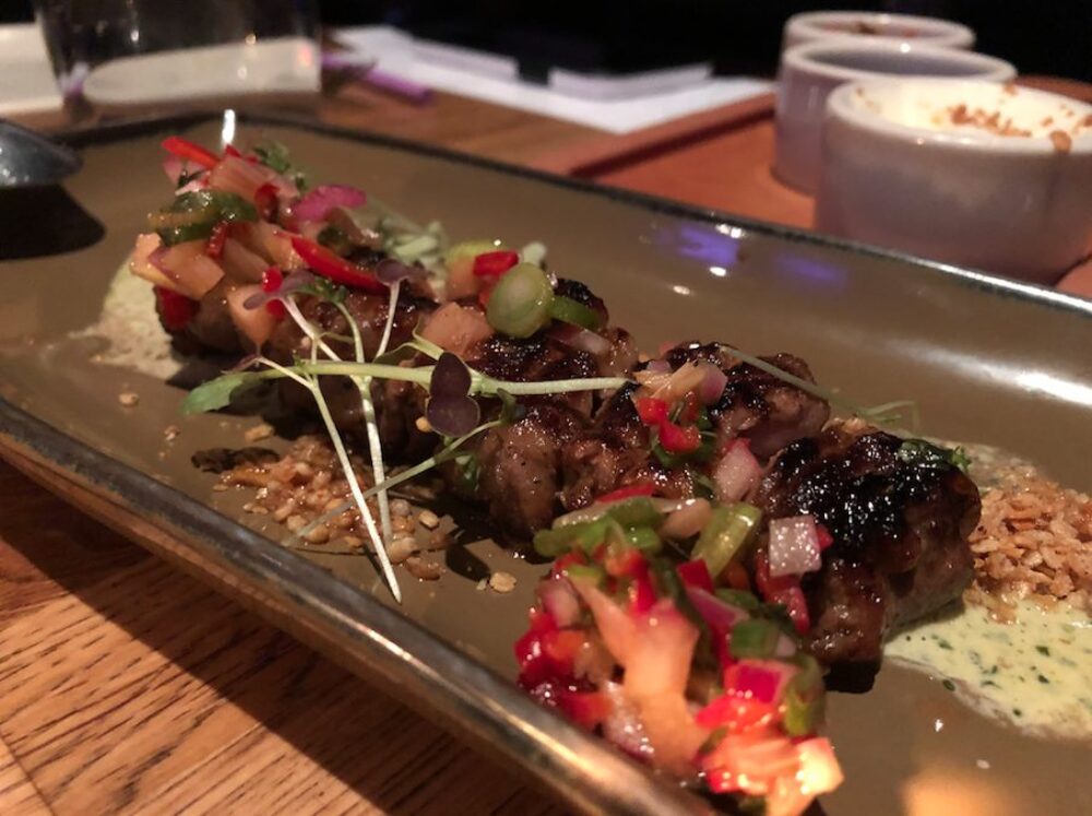 One of the second course dishes: Marinated Lamb Skewers with rhubarb relish, cilantro yuzu vinaigrette and garlic crunch. for ICYMI: Leading Chefs Came Together ‘Around the Table’ to Support the Alzheimer’s Association at Girl & the Goat May 4