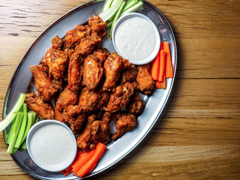 The Fifty/50 is offering pre order Super Bowl carryout packages featuring its award wining chicken wings. (Courtesy of Sarah Zelman – The Fifty/50) for What To Order For Super Bowl Sunday