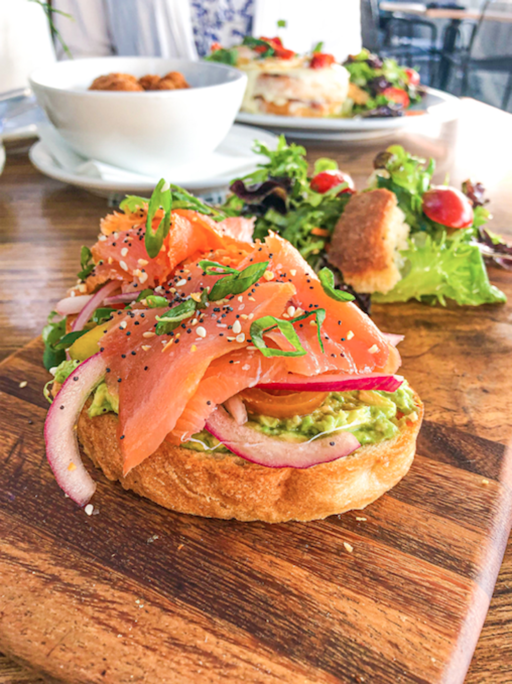 This Smoked Salmon Toast is as delicious as it is beautiful. A generous amount of smashed avocado and slices of marinated tomatoes welcome the delicate smoked salmon topped with crunchy everything bagel seasoning. for Weekend Brunch is Back at Frasca Pizzeria Featuring Bottomless Aperol Spritz’, Rose Sangria and Mimosas