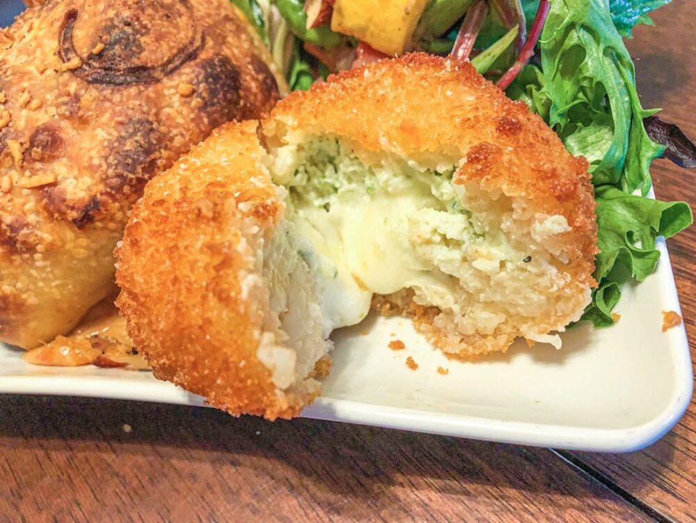 The Wild Garlic Arancini balled up and fried with vegetarian risotto combined with young garlic, ricotta and mozzarella cheese. for Sfera Sicilian Street Food: a Flavor Packed Culinary Tour Through the Streets of Sicily