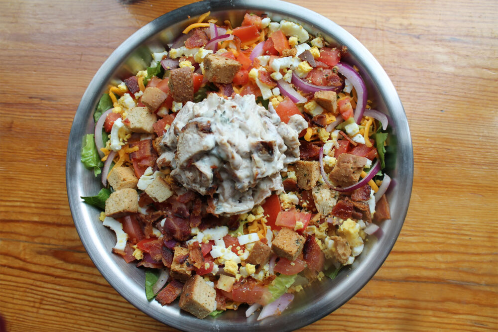 The Cobb Salad: Romaine Lettuce, Chicken Salad, Bacon, Cheddar Cheese, Hard Boiled Egg, Tomato, Red Onion and Croutons. Photo by Lauren Widor for The Boiler Room Debuts Summer Menu Items