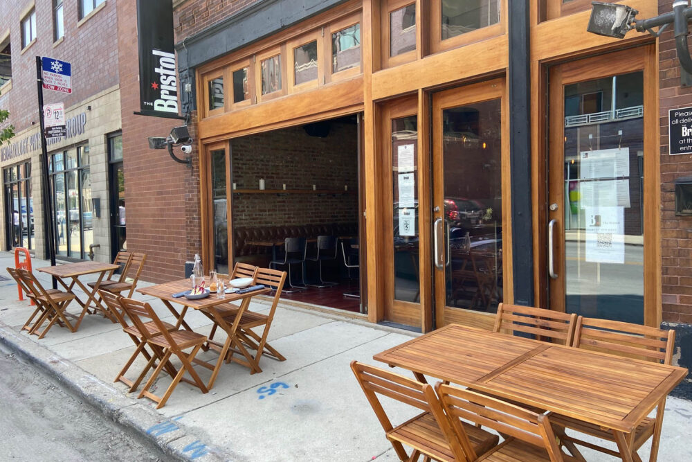 Street side patio seating along Damen Ave. for The Bristol Debuts Family Style Food and Booze Options To Go