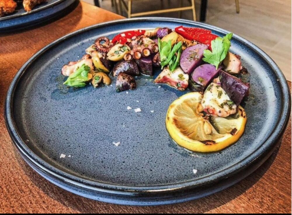 The warm octopus salad at Oaken Bistro + Bar (Photo by Chicago Food Magazine) for Best Places to Celebrate National Seafood Month in October